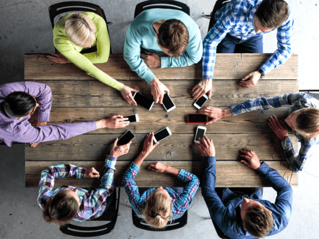 Stand out from the crowd of people gathered around table.