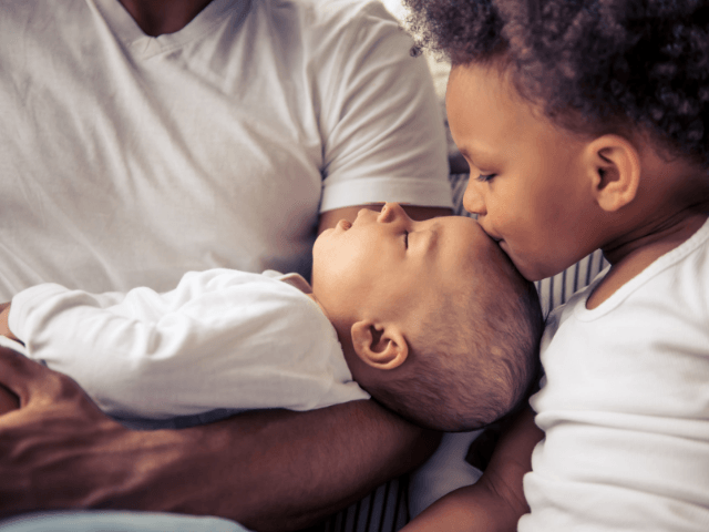 How bloggers stand out from the crowd. Little kid kissing baby sibling.